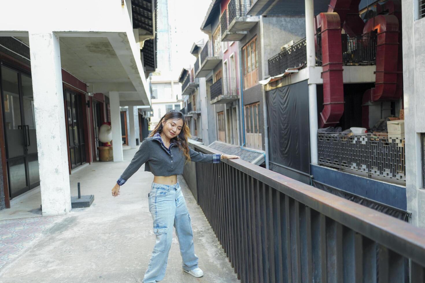 Asian women do freestyle hip hop and breakdancing in a public space in the middle of the city. With a cheerful and happy attitude photo