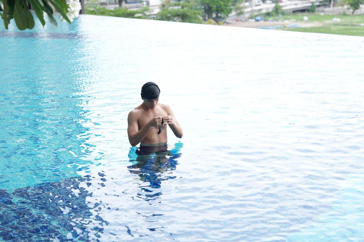 Asian men practicing swimming and preparing to play water polo and stretching and resting for water sports. photo