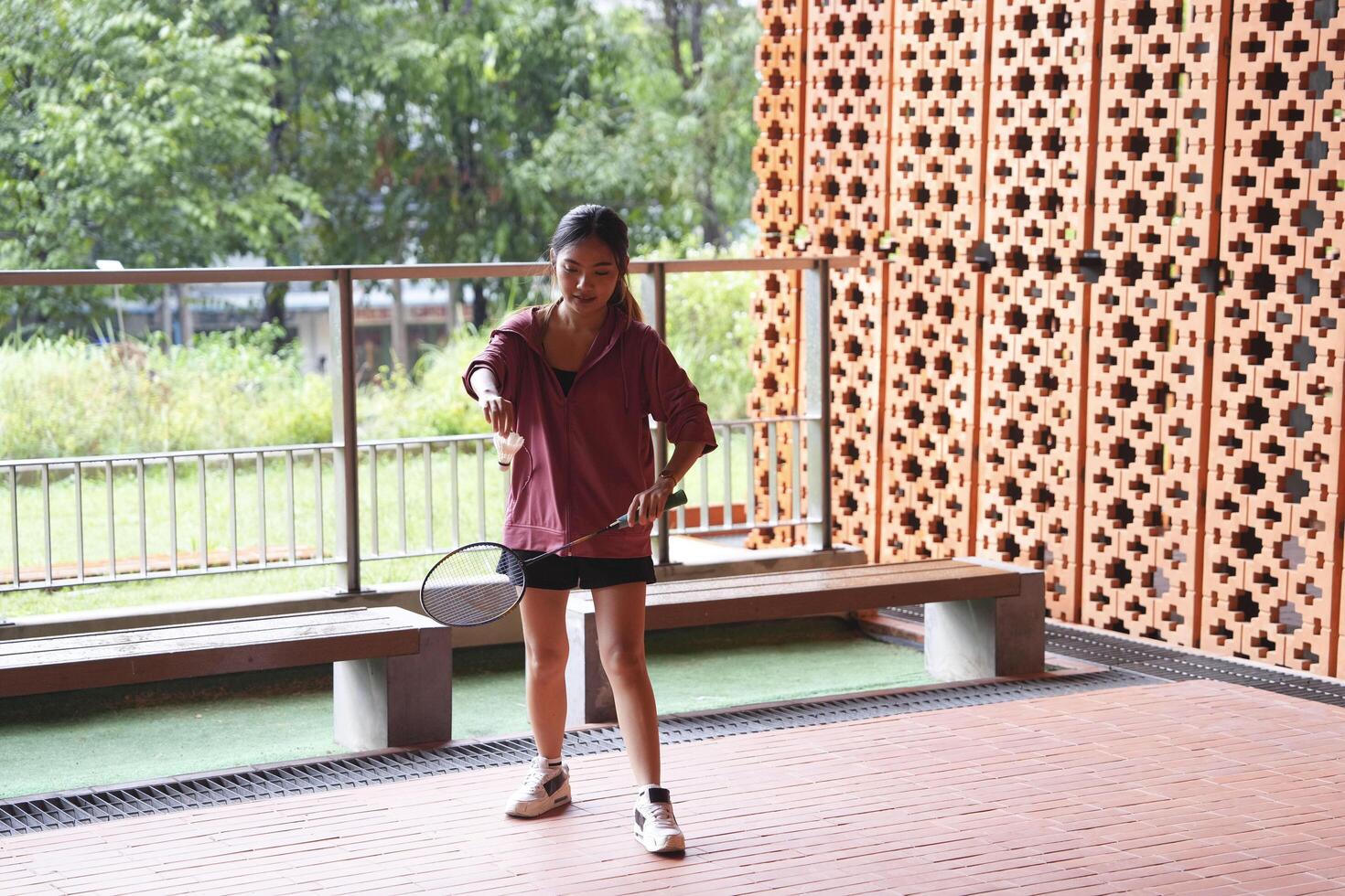 Young people play badminton and repair diligently in the park area. photo