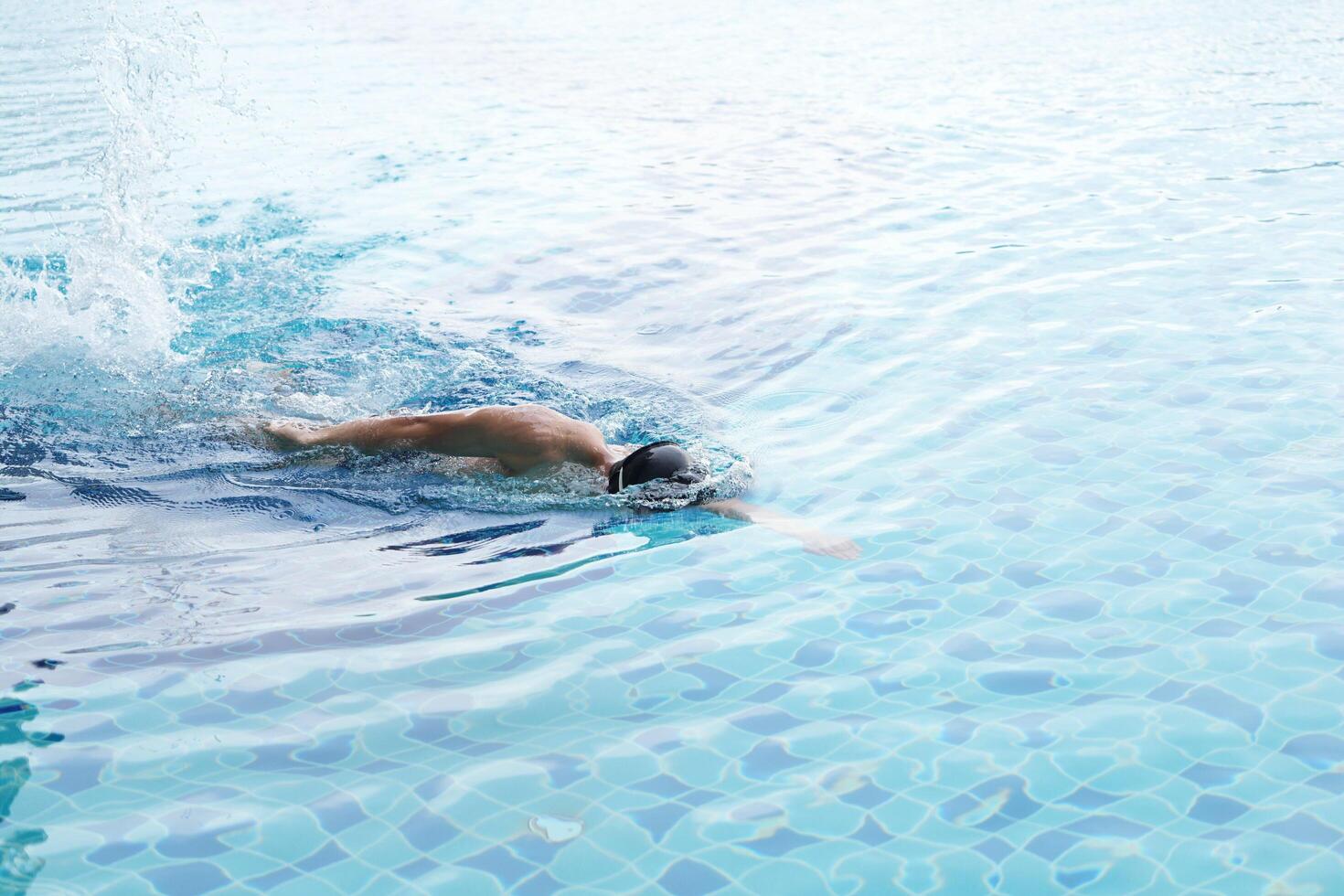 Asian men practicing swimming and preparing to play water polo and stretching and resting for water sports. photo