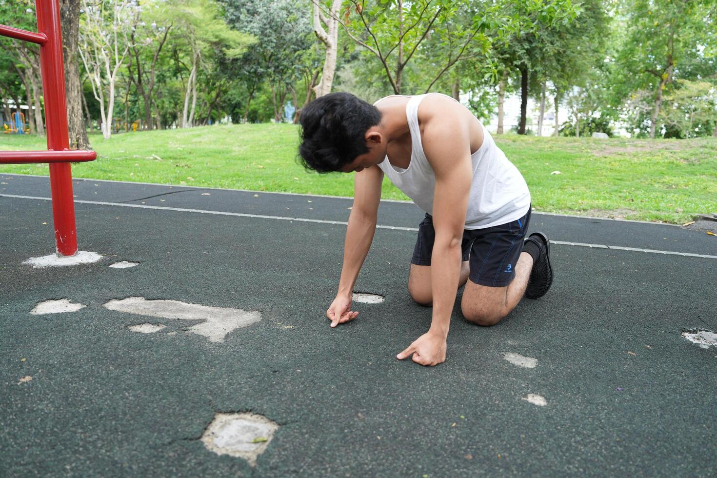 Asian man practicing gymnastics doing gymnastics bar and hoop exercises and stretching and resting for sports. photo