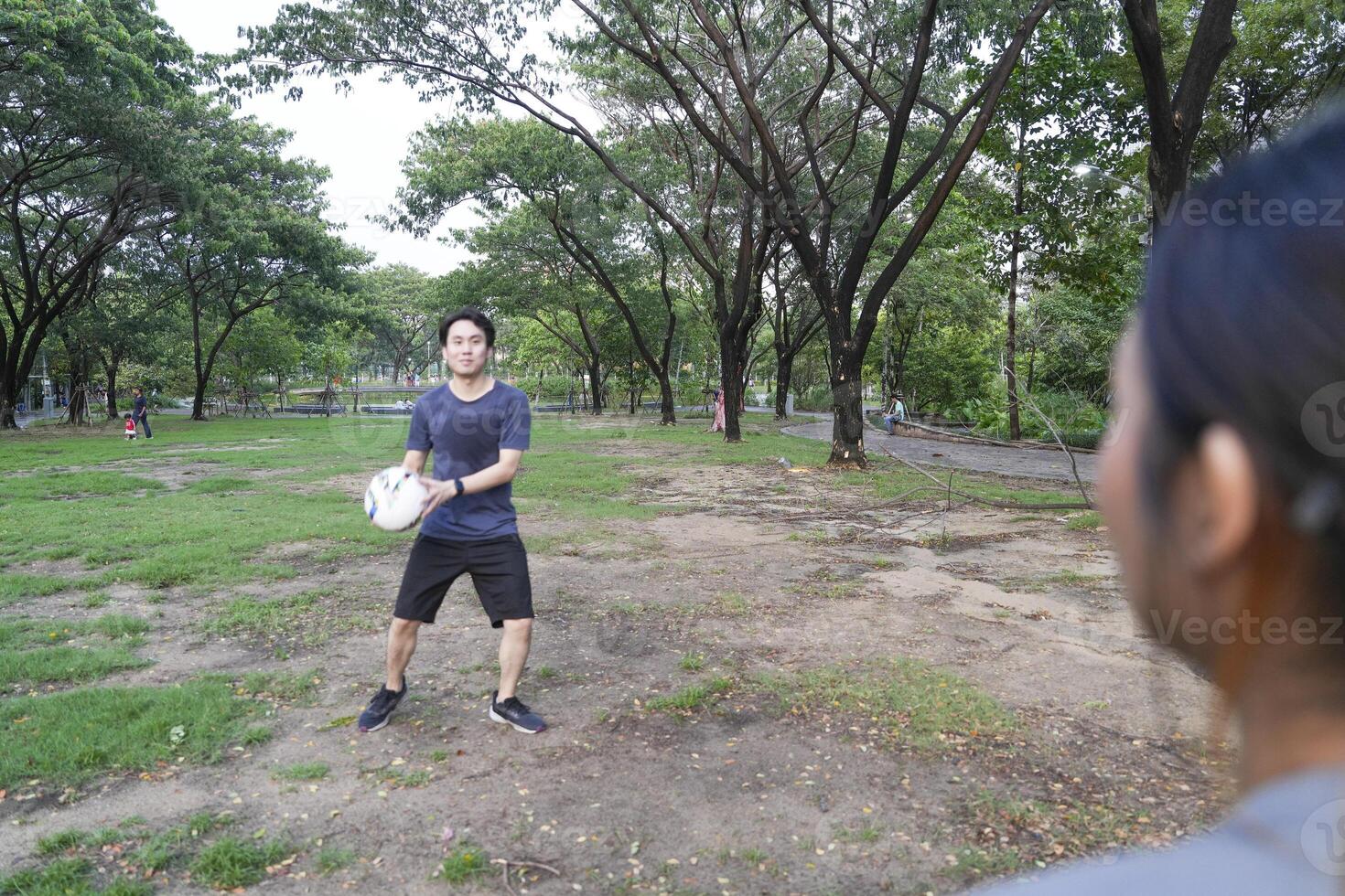 Male and female soccer players practice using the ball in the park field diligently and happily. photo