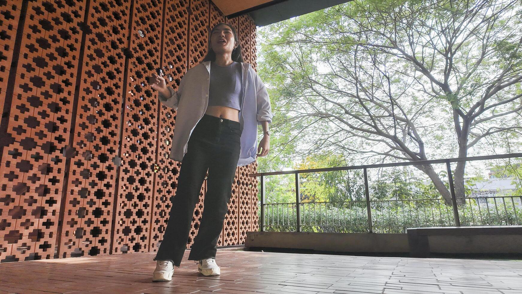 Asian girl dancing hip hop having fun With brightness and cheerfulness in the park area photo