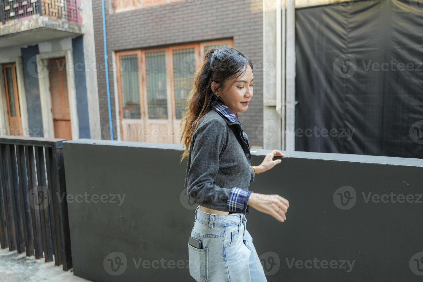 Asian women do freestyle hip hop and breakdancing in a public space in the middle of the city. With a cheerful and happy attitude photo