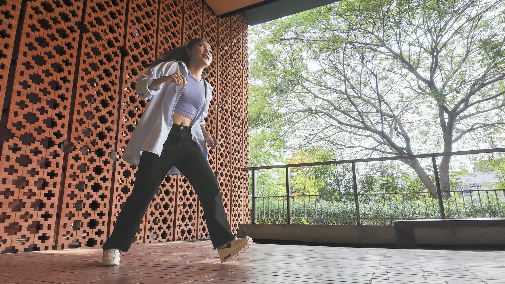 Asian girl dancing hip hop having fun With brightness and cheerfulness in the park area photo