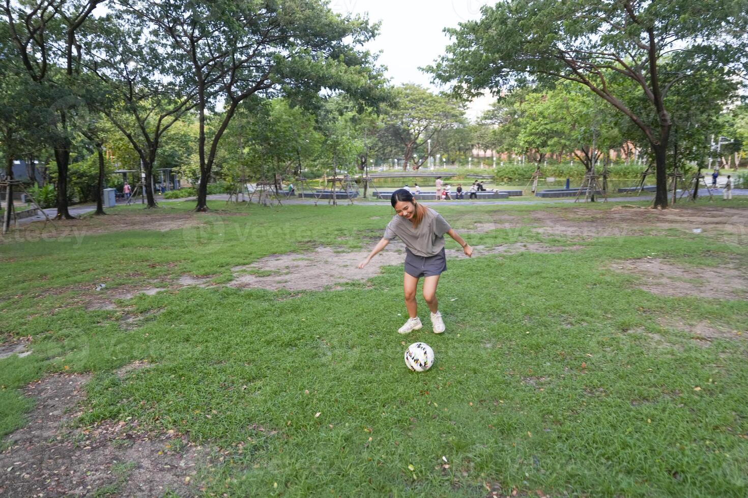 female soccer players practice using the ball in the park field diligently and happily. photo