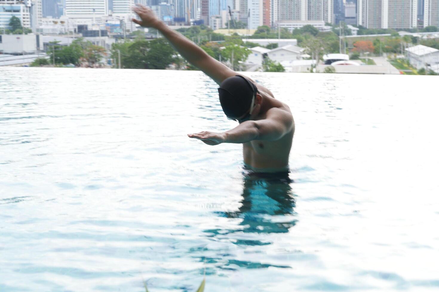 Asian men practicing swimming and preparing to play water polo and stretching and resting for water sports. photo