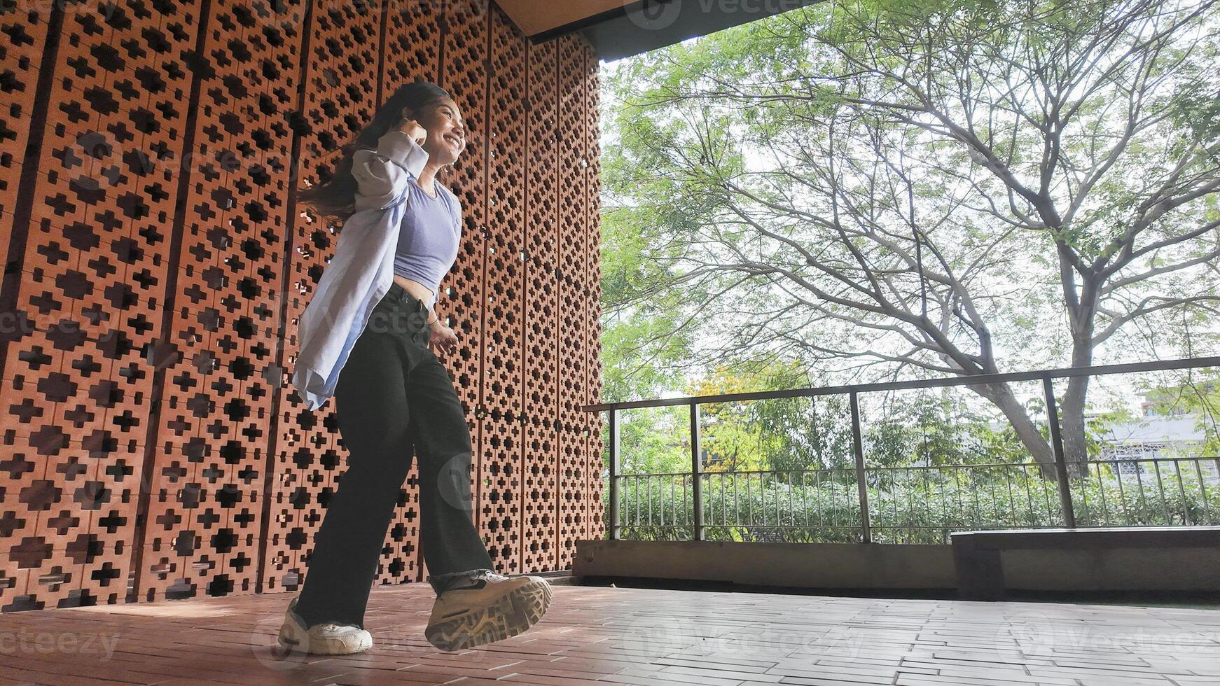 Asian girl dances freestyle hip-hop in an open space. photo