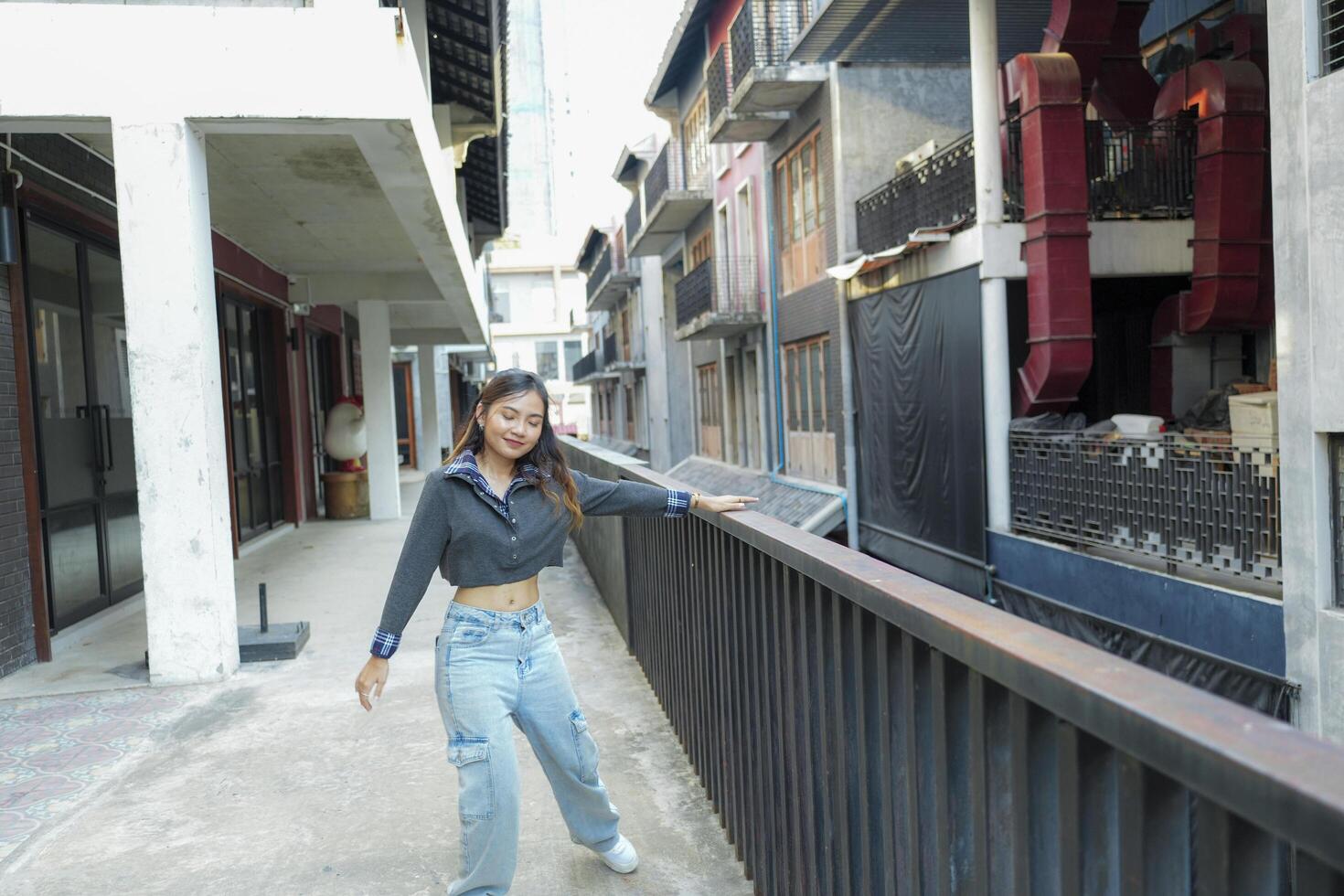 Asian women do freestyle hip hop and breakdancing in a public space in the middle of the city. With a cheerful and happy attitude photo