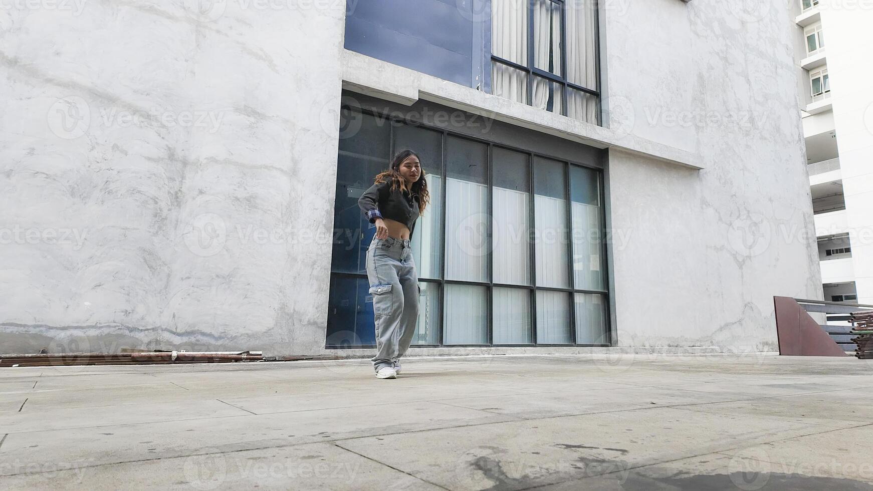 Asian women do freestyle hip hop and breakdancing in a public space in the middle of the city. With a cheerful and happy attitude photo