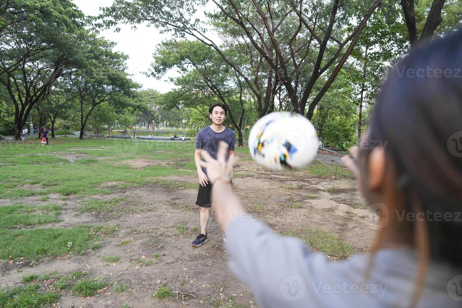 Male and female soccer players practice using the ball in the park field diligently and happily. photo