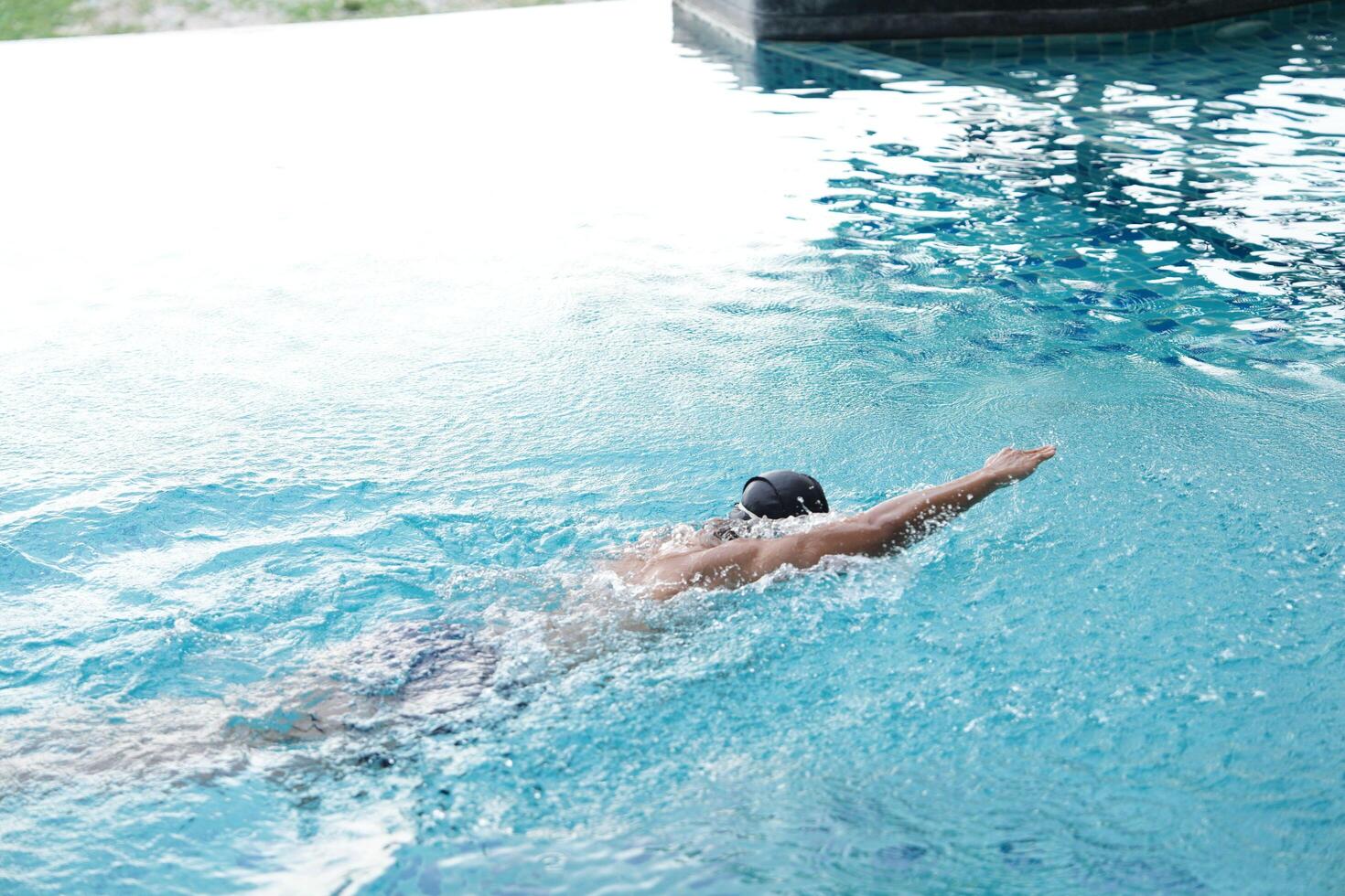 Asian men practicing swimming and preparing to play water polo and stretching and resting for water sports. photo