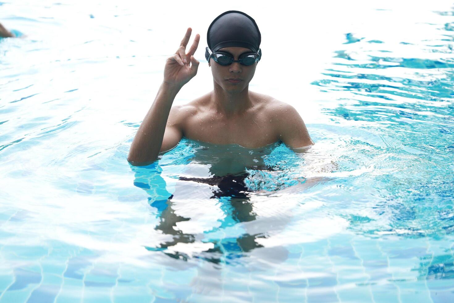 Asian men practicing swimming and preparing to play water polo and stretching and resting for water sports. photo