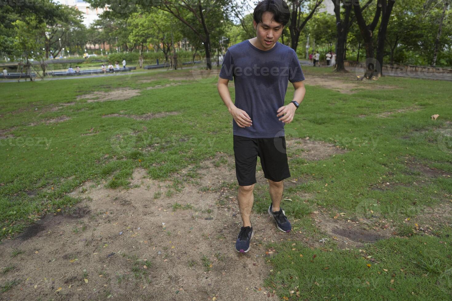 Male soccer players practice using the ball in the park field diligently and happily. photo