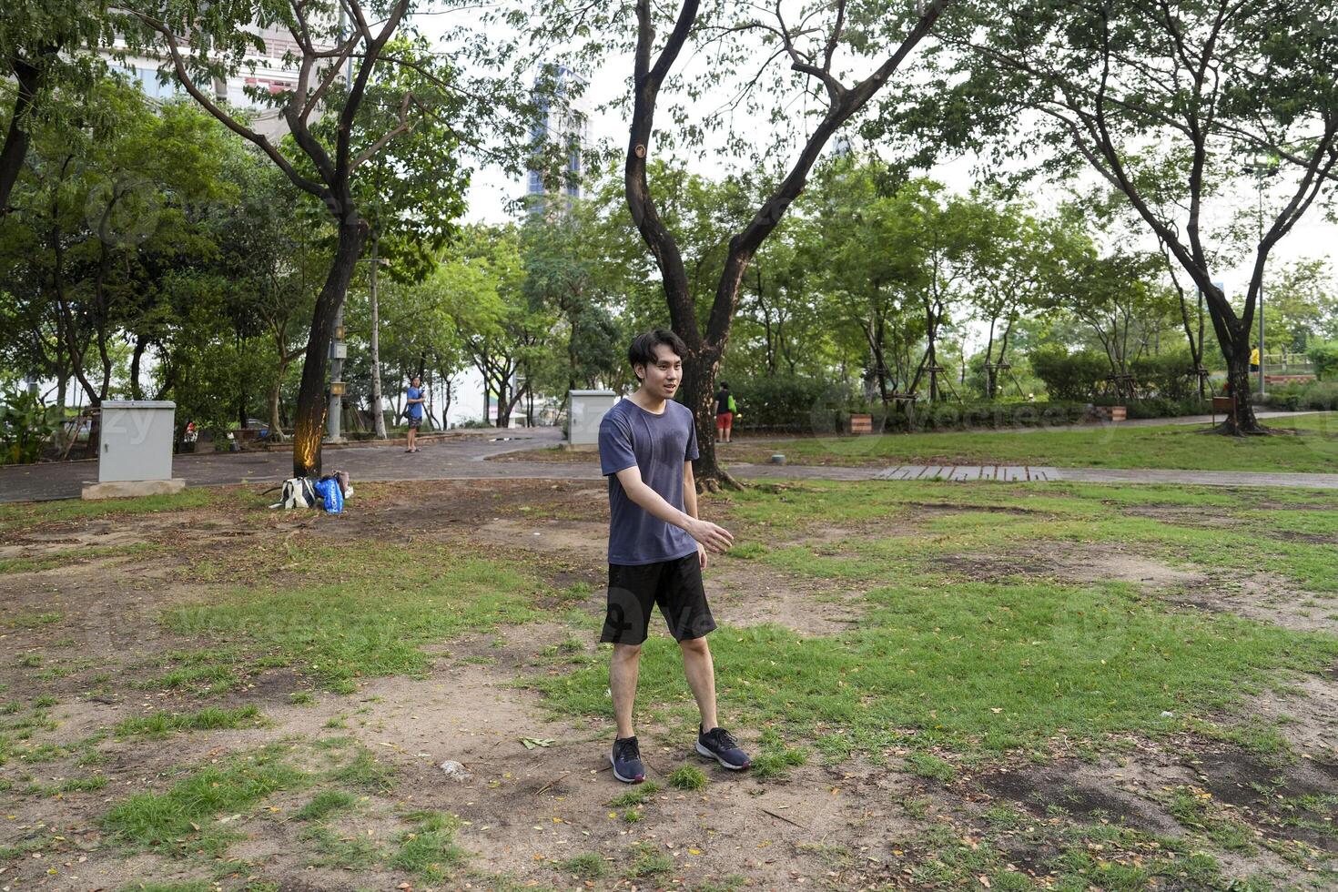 Male soccer players practice using the ball in the park field diligently and happily. photo