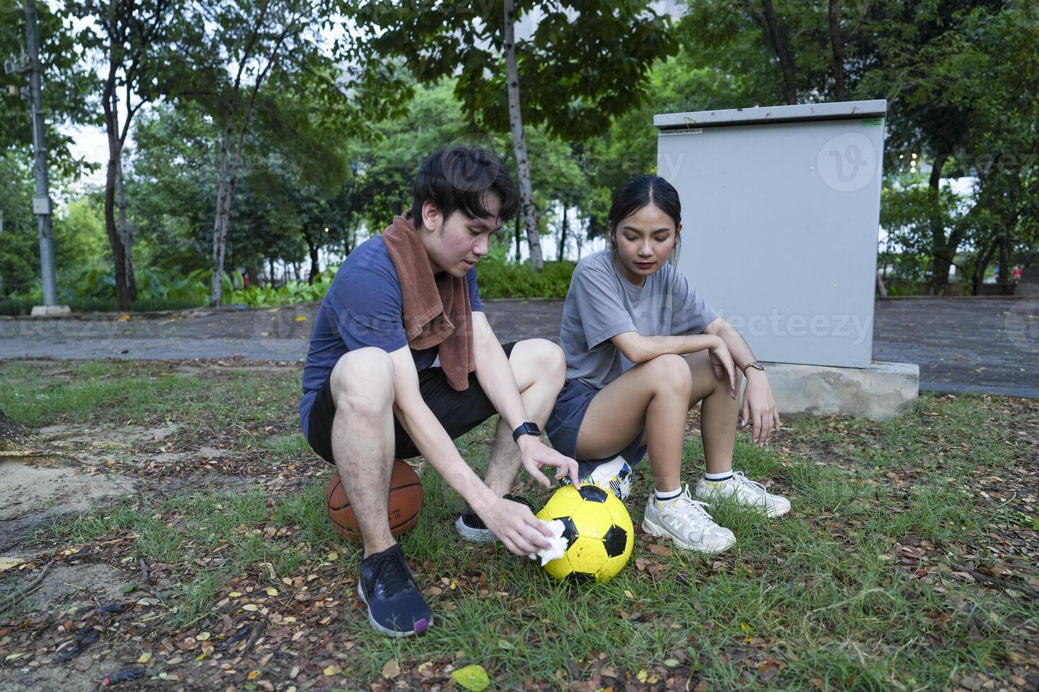 Male and female soccer players practice using the ball in the park field diligently and happily. photo