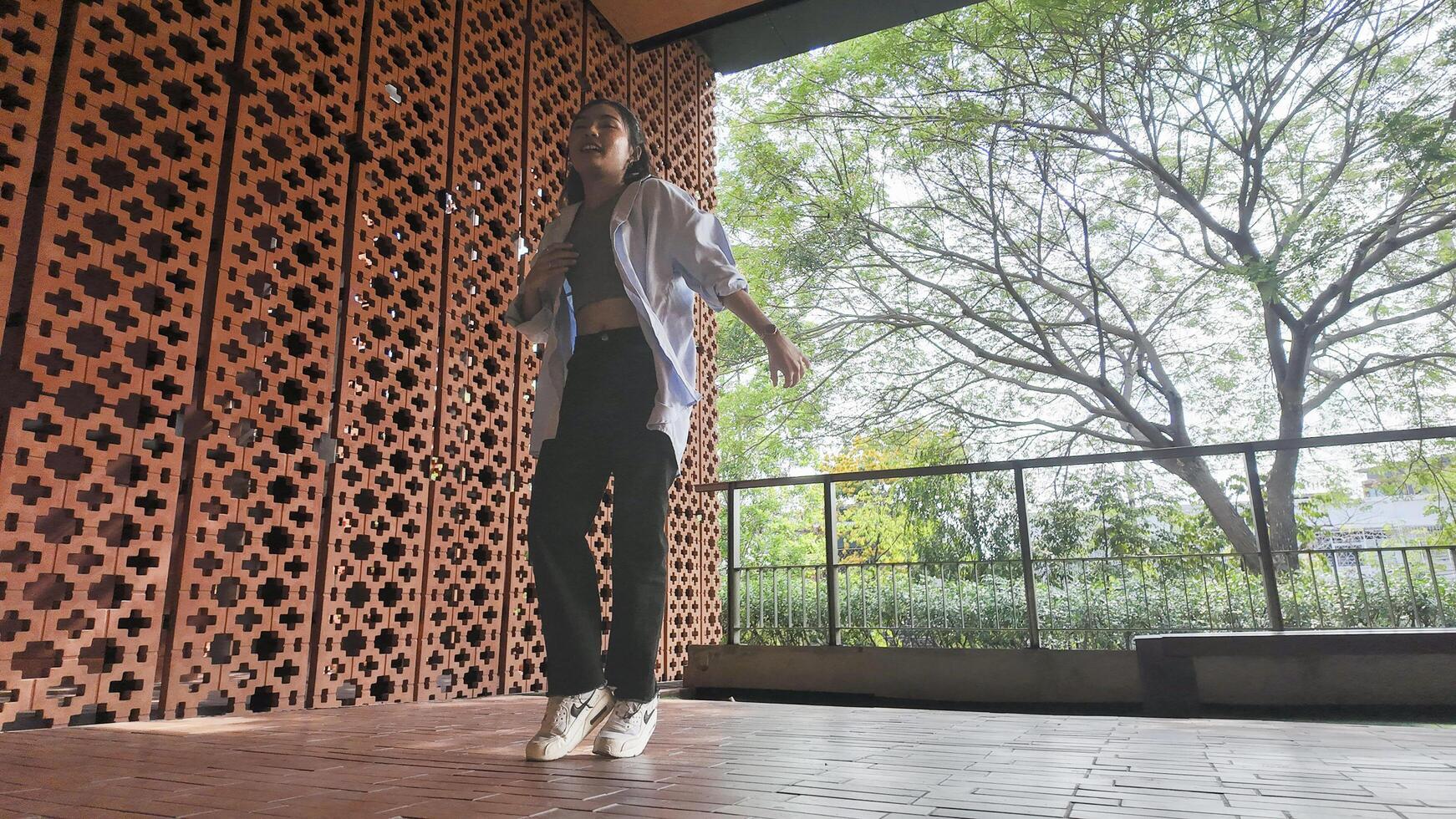 Asian girl dancing hip hop having fun With brightness and cheerfulness in the park area photo