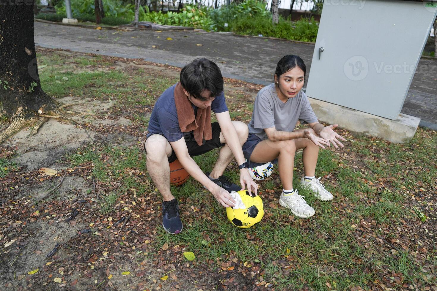 Male and female soccer players practice using the ball in the park field diligently and happily. photo