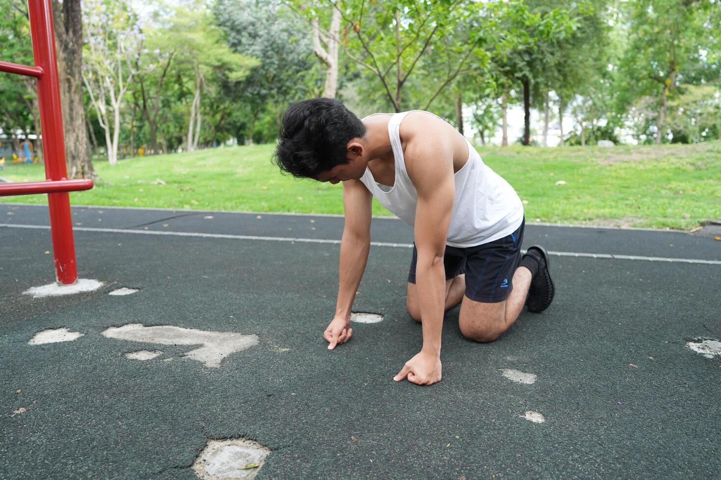 Asian man practicing gymnastics doing gymnastics bar and hoop exercises and stretching and resting for sports. photo