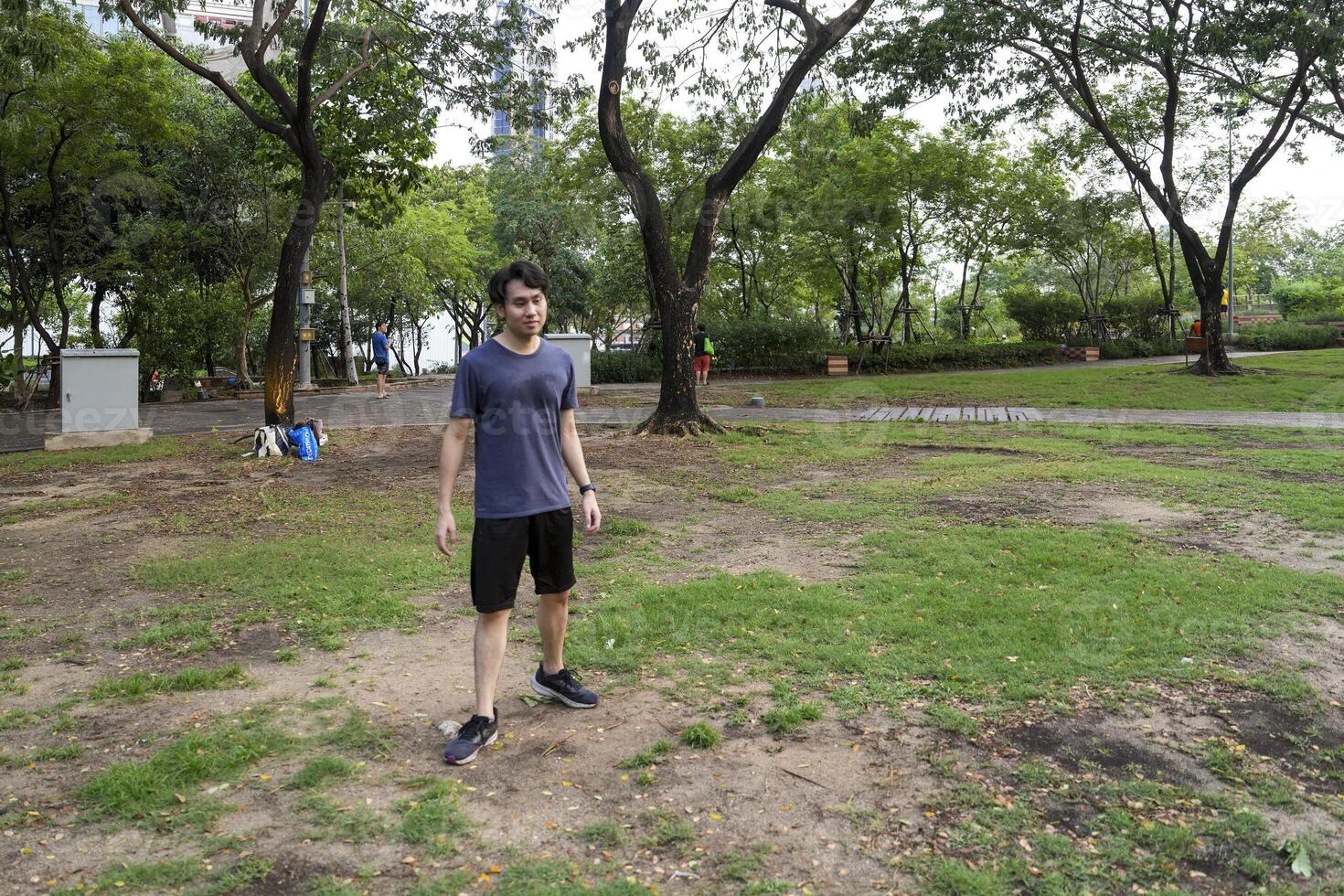 Male soccer players practice using the ball in the park field diligently and happily. photo