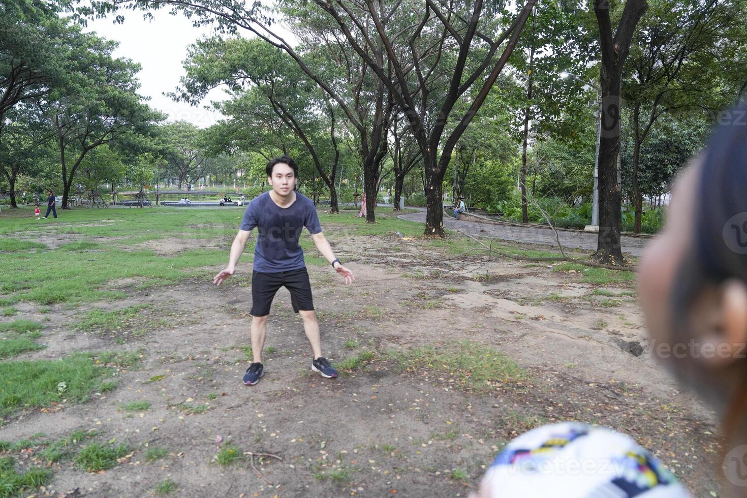 Male and female soccer players practice using the ball in the park field diligently and happily. photo