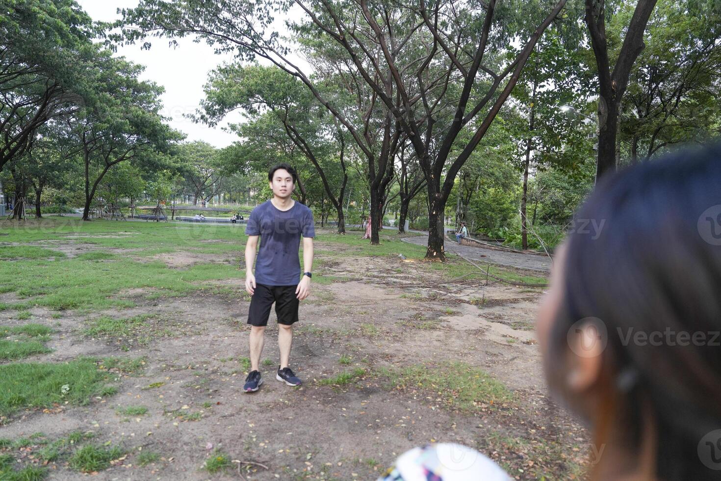 Male and female soccer players practice using the ball in the park field diligently and happily. photo