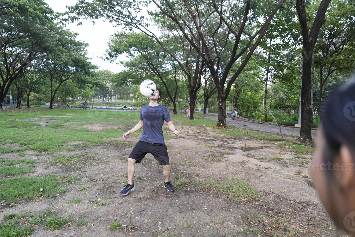 Male and female soccer players practice using the ball in the park field diligently and happily. photo
