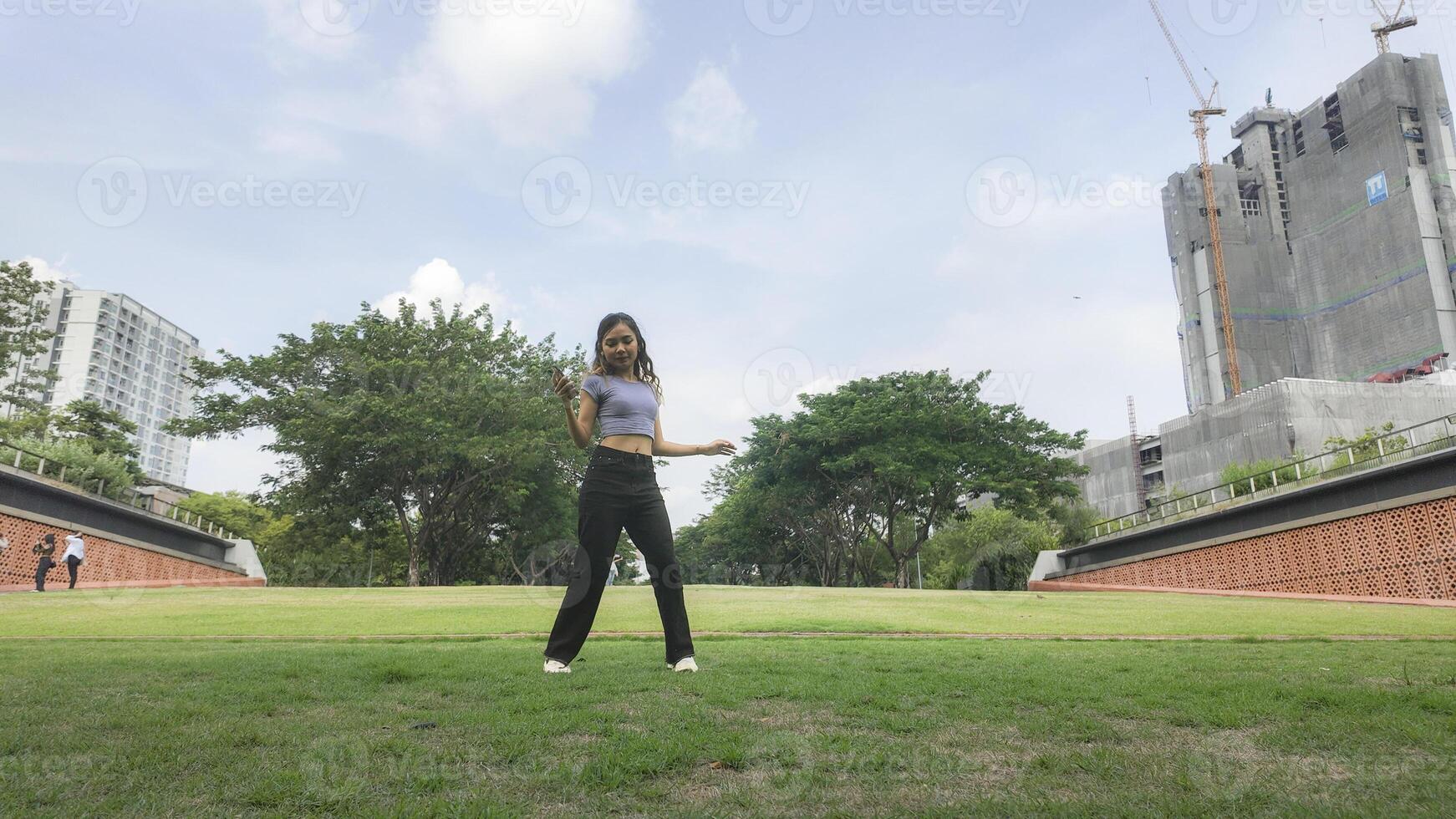 Asian women do freestyle hip hop and breakdancing in a public space in the middle of the city. With a cheerful and happy attitude photo