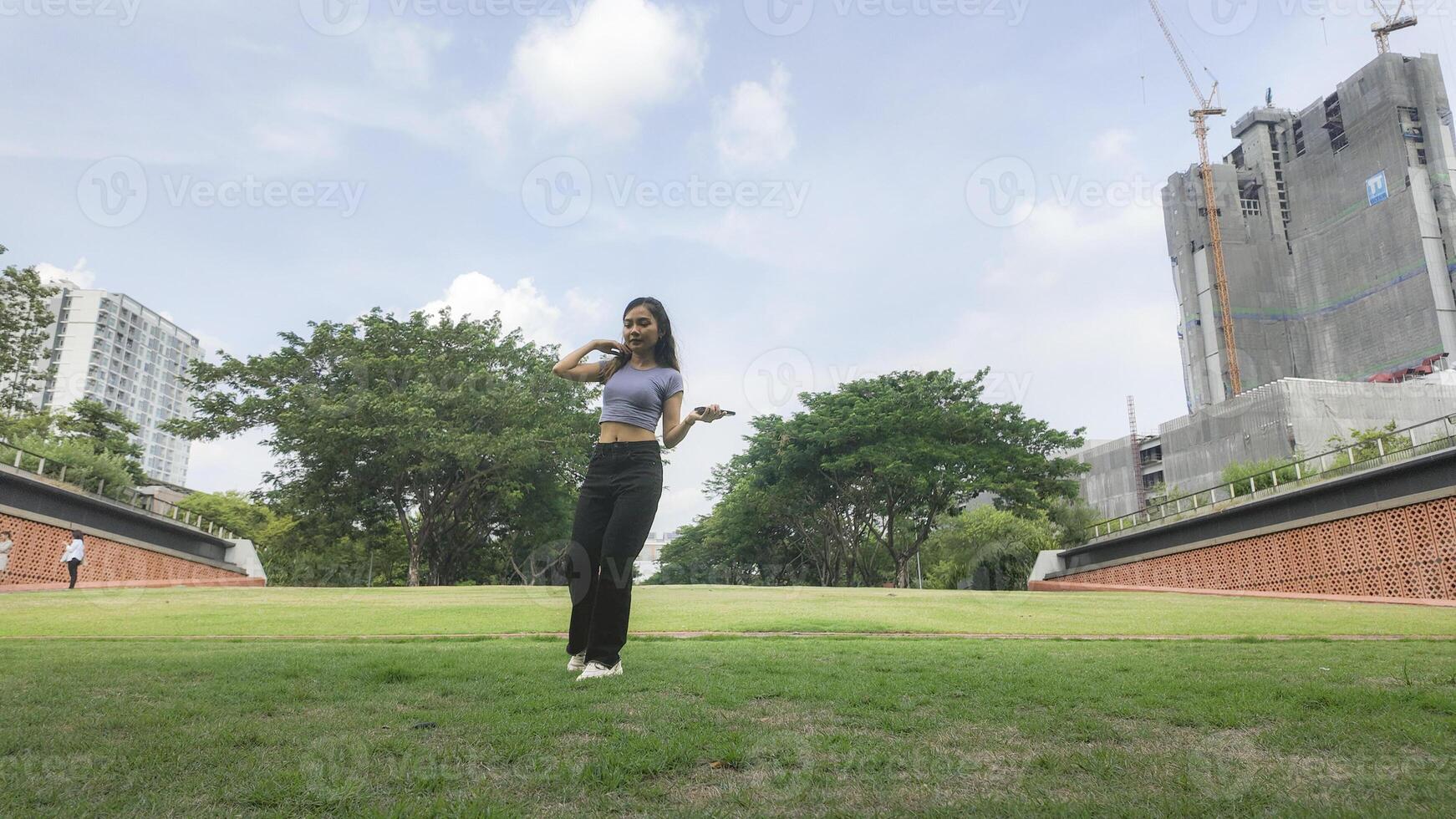Asian women do freestyle hip hop and breakdancing in a public space in the middle of the city. With a cheerful and happy attitude photo