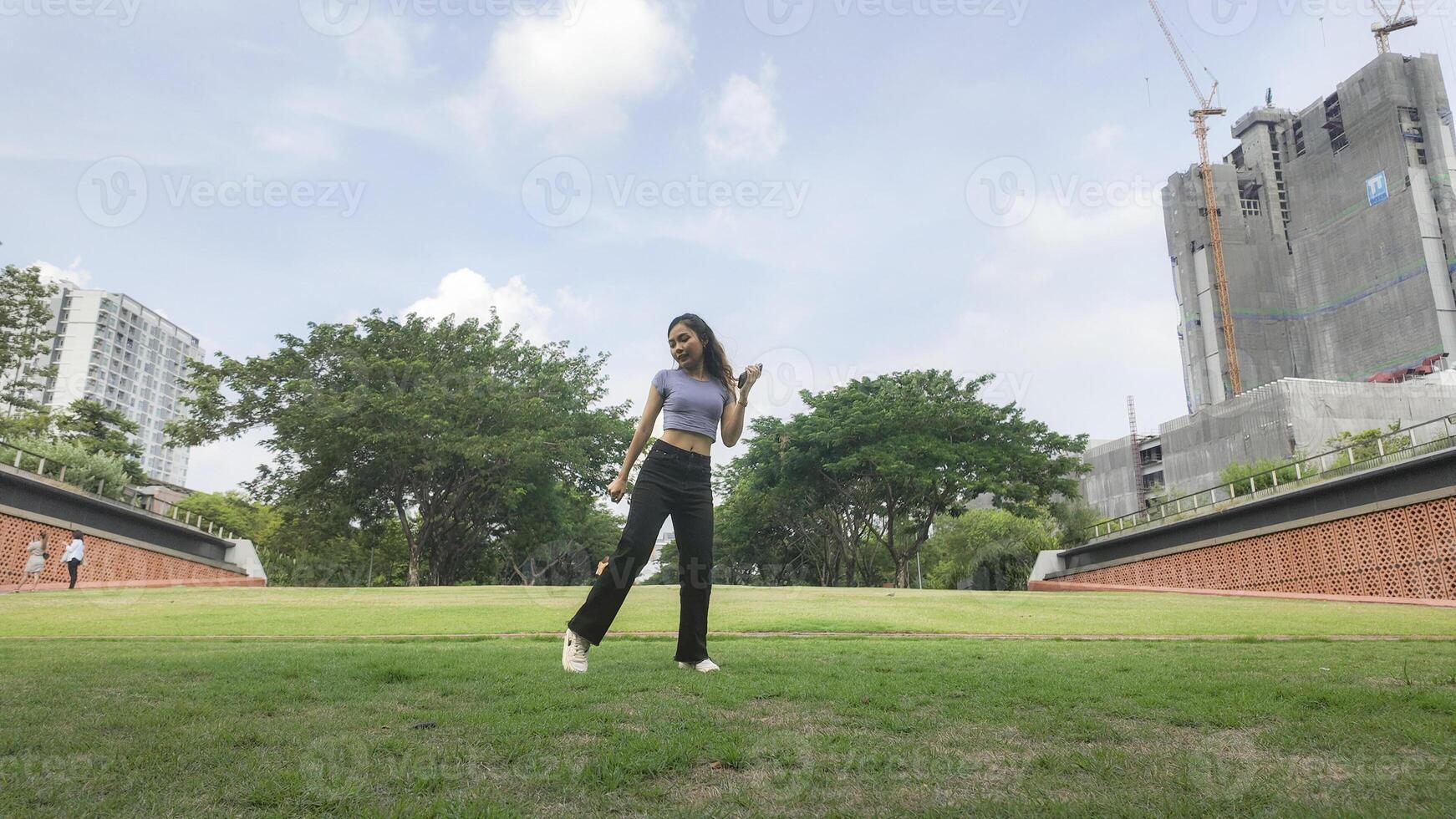 Asian women do freestyle hip hop and breakdancing in a public space in the middle of the city. With a cheerful and happy attitude photo