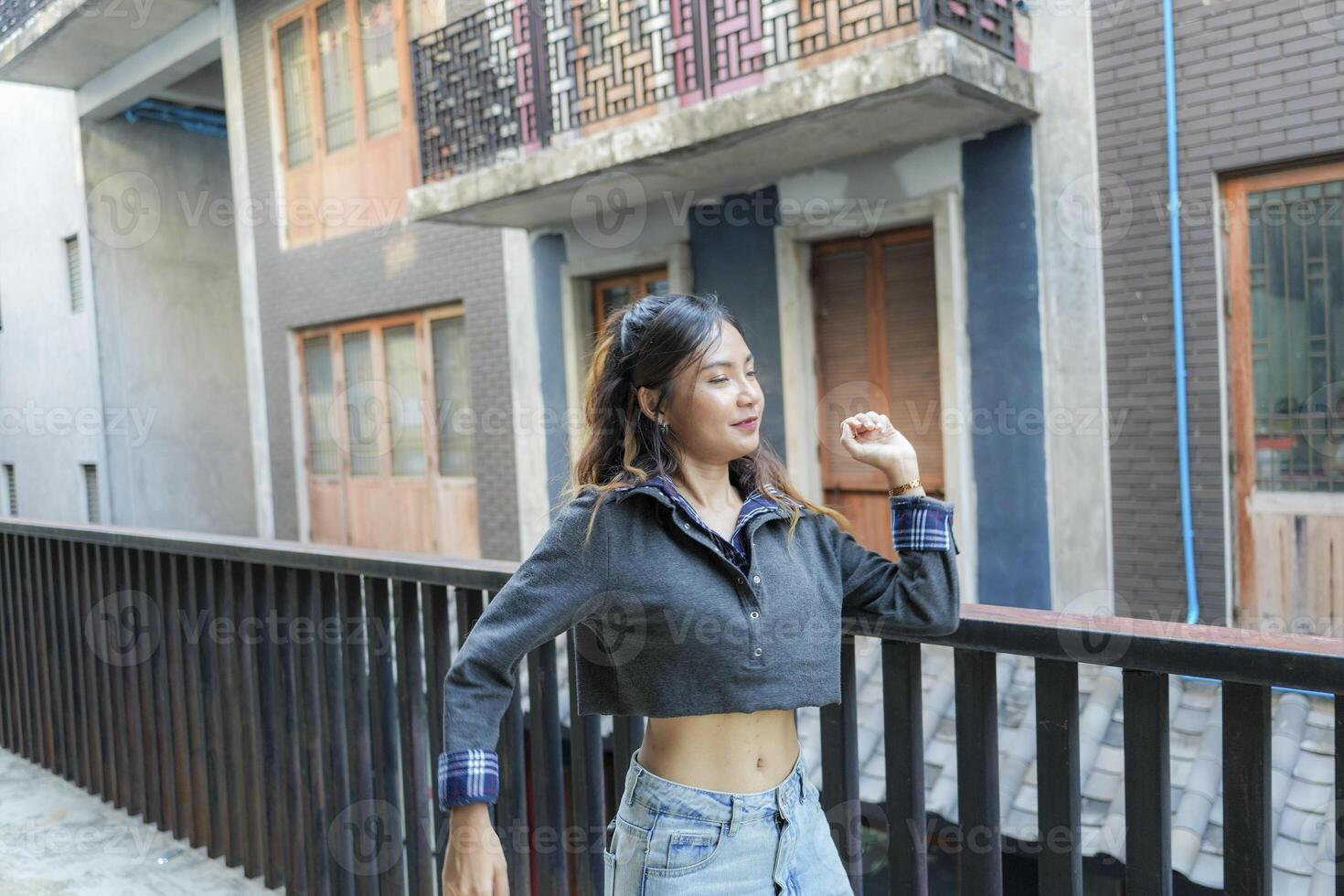 Asian women do freestyle hip hop and breakdancing in a public space in the middle of the city. With a cheerful and happy attitude photo