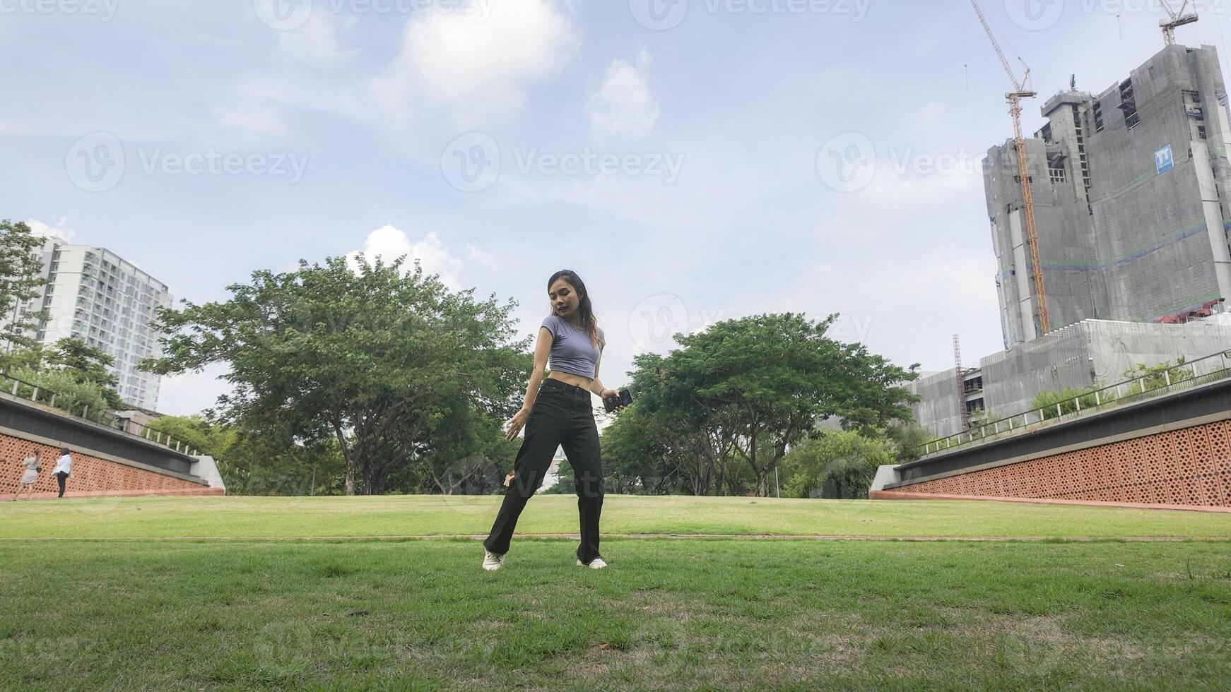 Asian women do freestyle hip hop and breakdancing in a public space in the middle of the city. With a cheerful and happy attitude photo