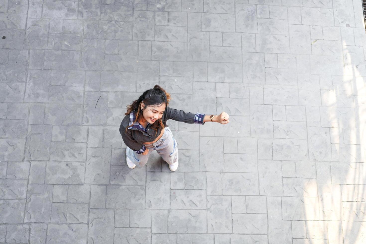 Asian women do freestyle hip hop and breakdancing in a public space in the middle of the city. With a cheerful and happy attitude photo