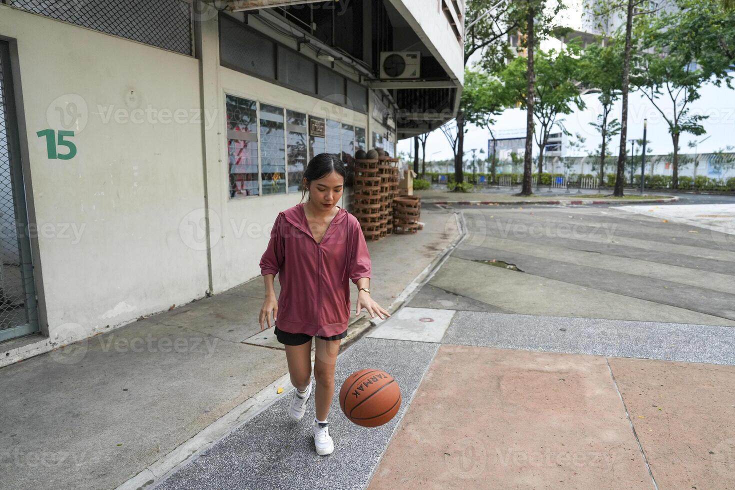 female basketball players practice using the ball in the park court diligently and happily. photo