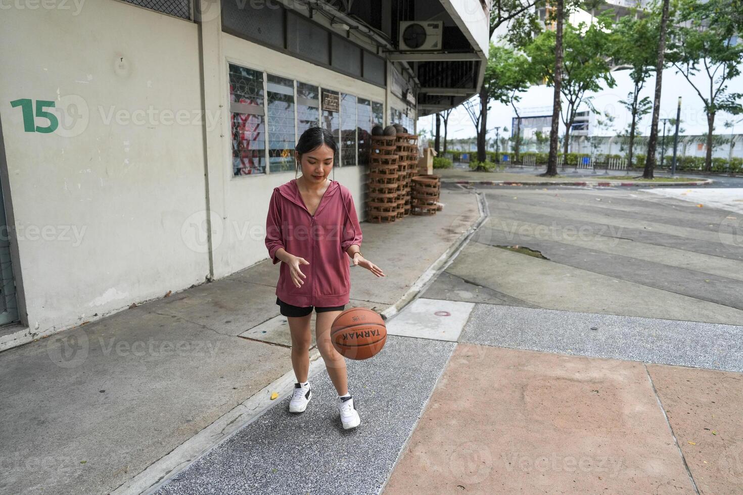 female basketball players practice using the ball in the park court diligently and happily. photo