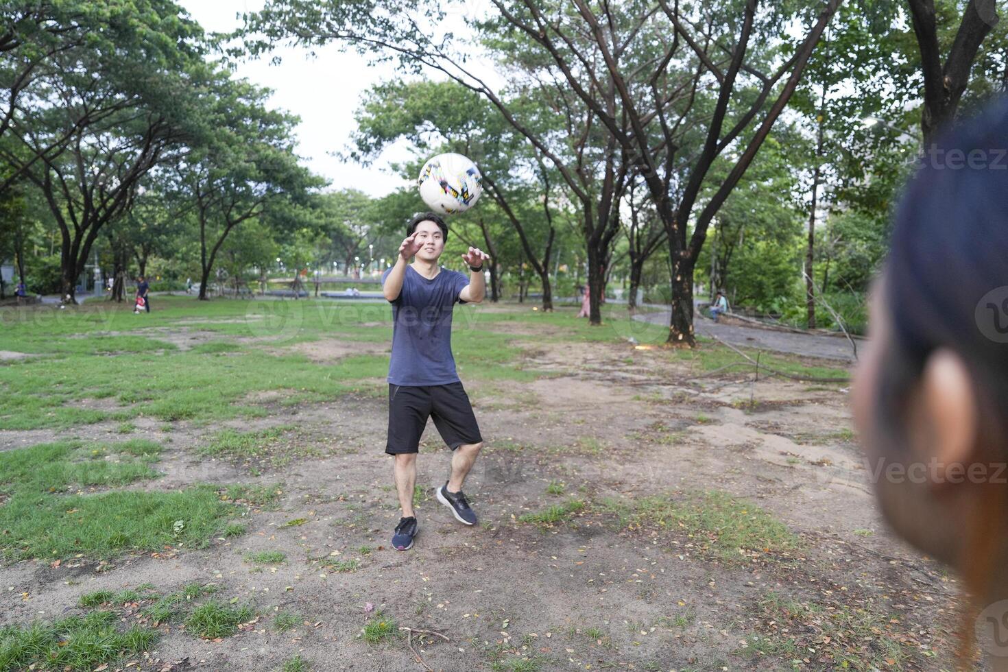 Male and female soccer players practice using the ball in the park field diligently and happily. photo