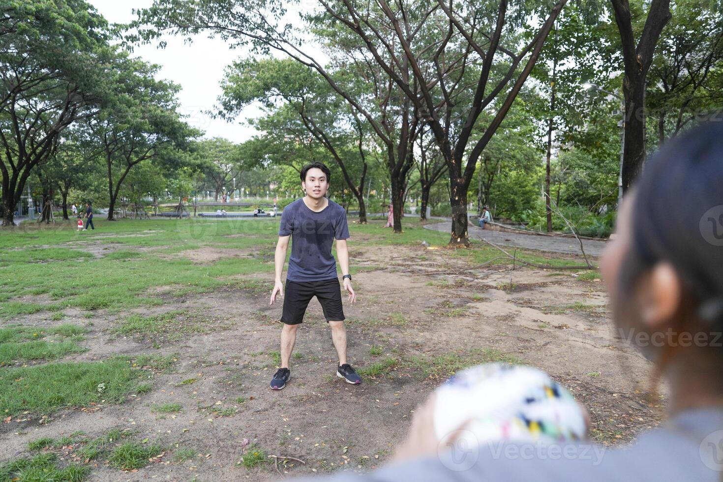 Male and female soccer players practice using the ball in the park field diligently and happily. photo