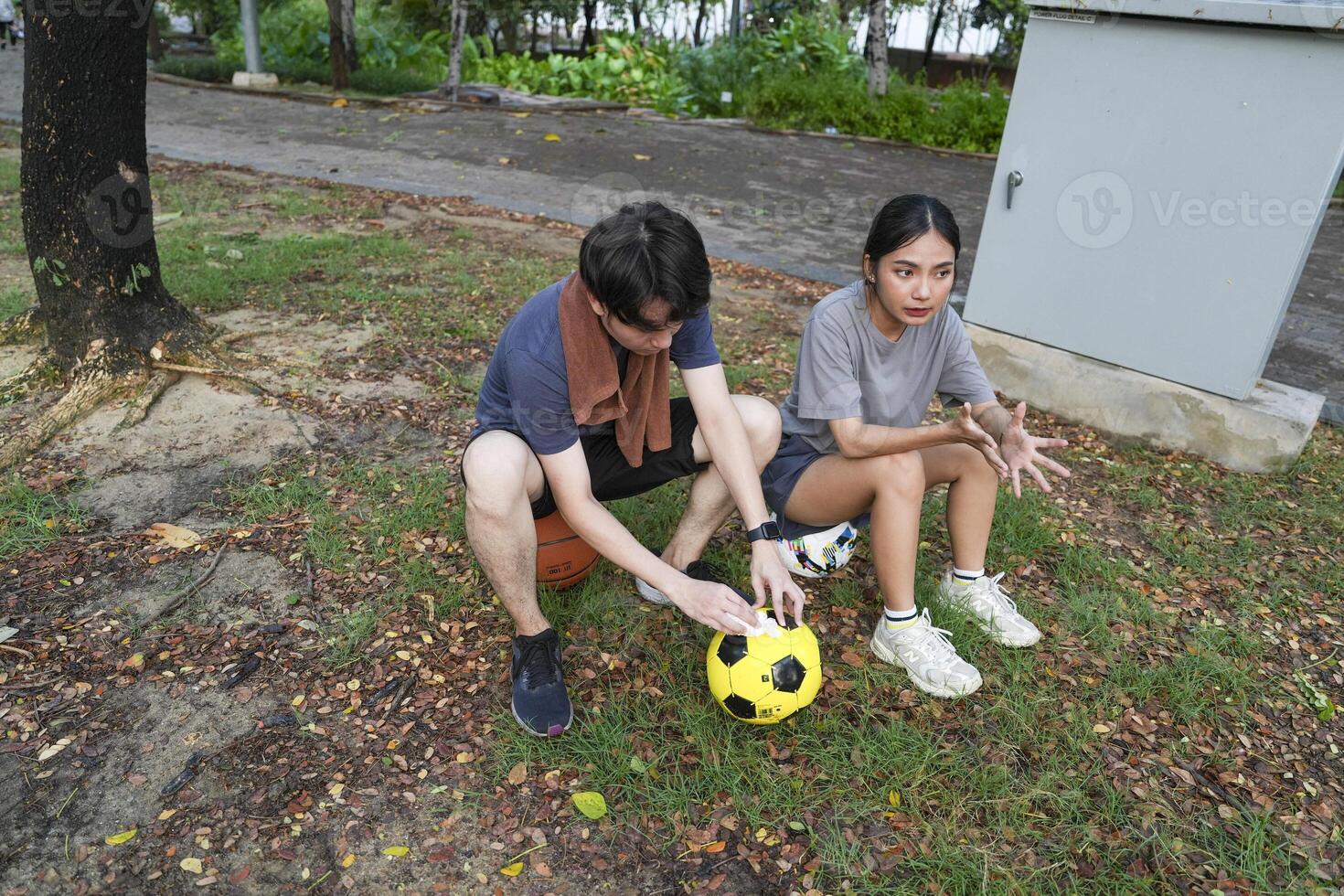 Male and female soccer players practice using the ball in the park field diligently and happily. photo
