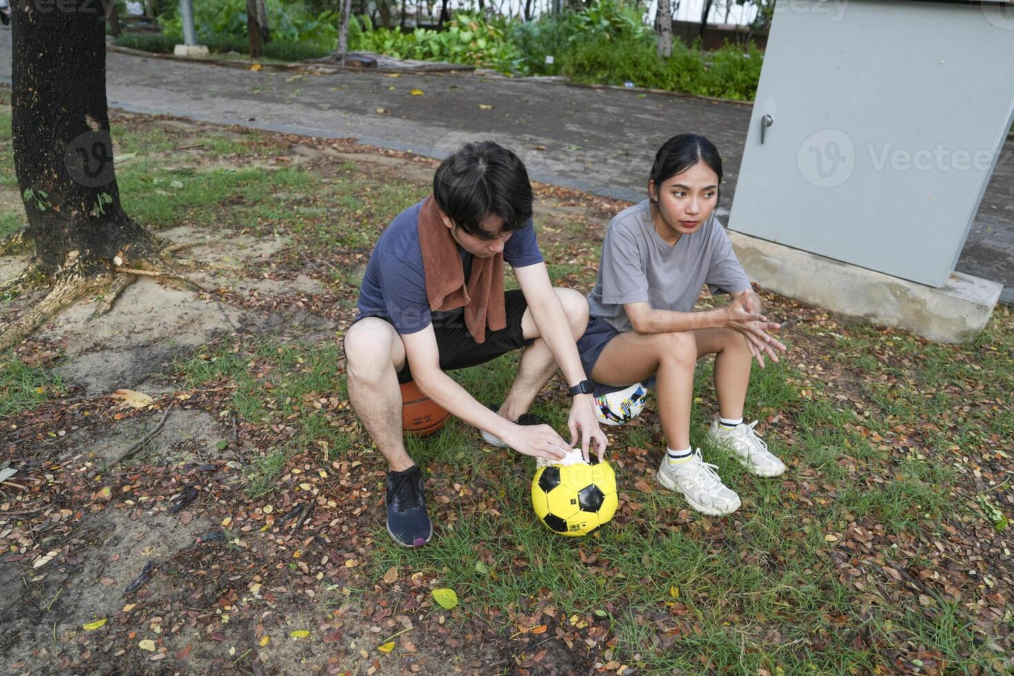 Male and female soccer players practice using the ball in the park field diligently and happily. photo