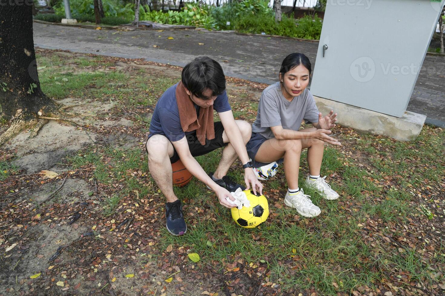 Male and female soccer players practice using the ball in the park field diligently and happily. photo