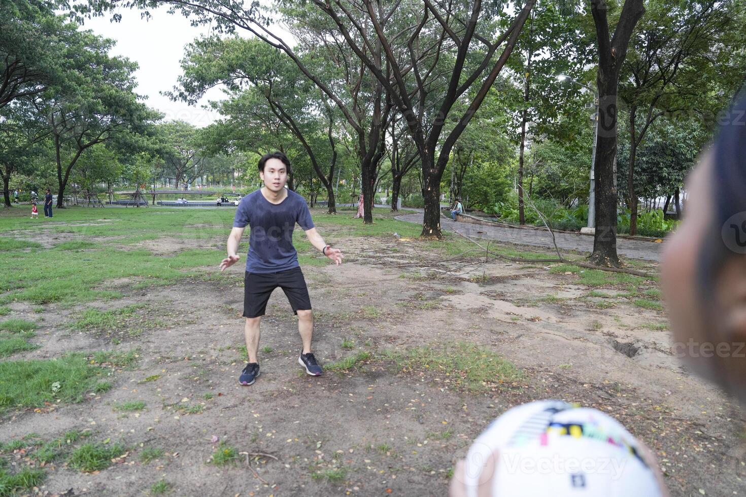 Male and female soccer players practice using the ball in the park field diligently and happily. photo
