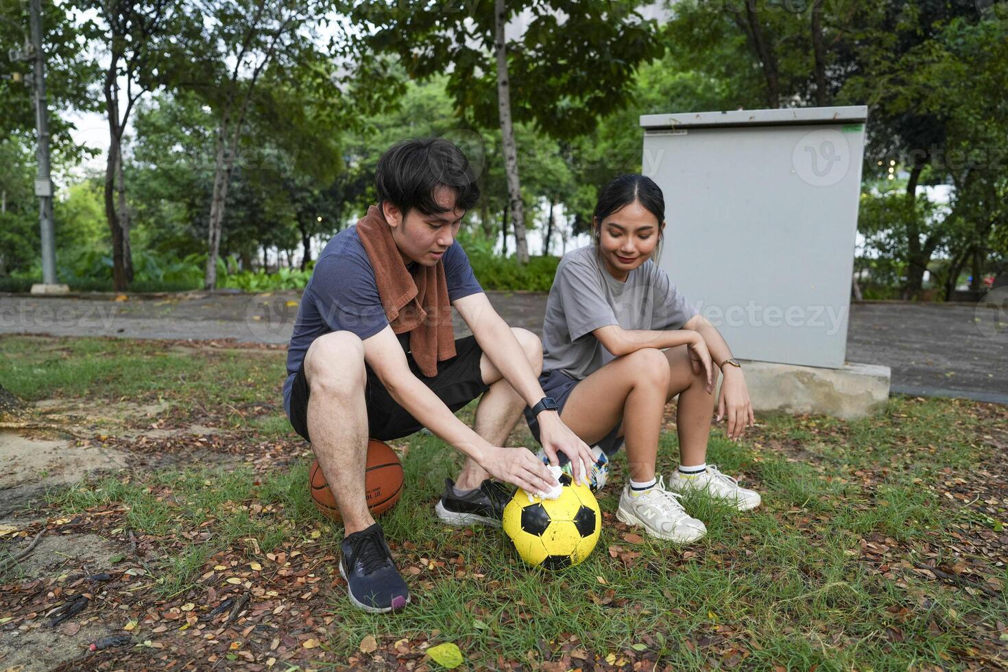 Male and female soccer players practice using the ball in the park field diligently and happily. photo