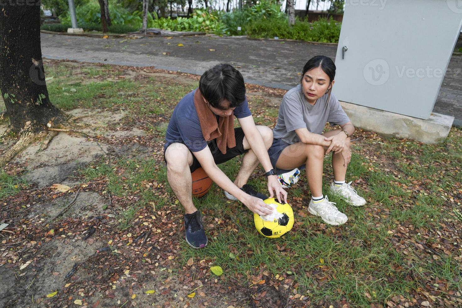Male and female soccer players practice using the ball in the park field diligently and happily. photo