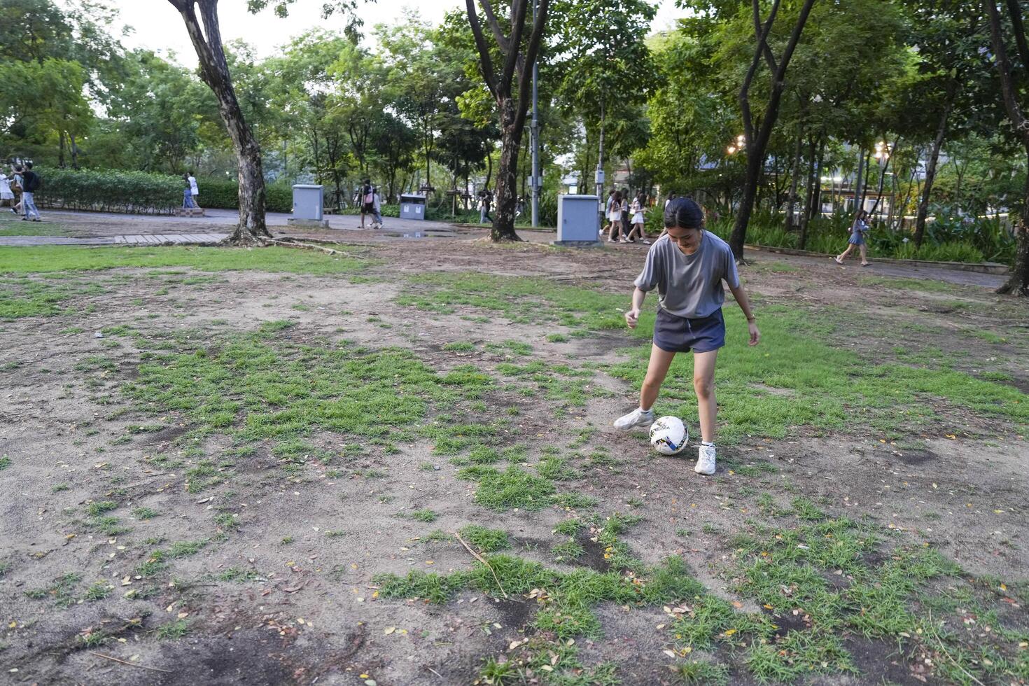 Male and female soccer players practice using the ball in the park field diligently and happily. photo