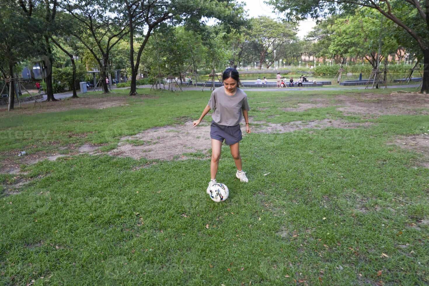 female soccer players practice using the ball in the park field diligently and happily. photo