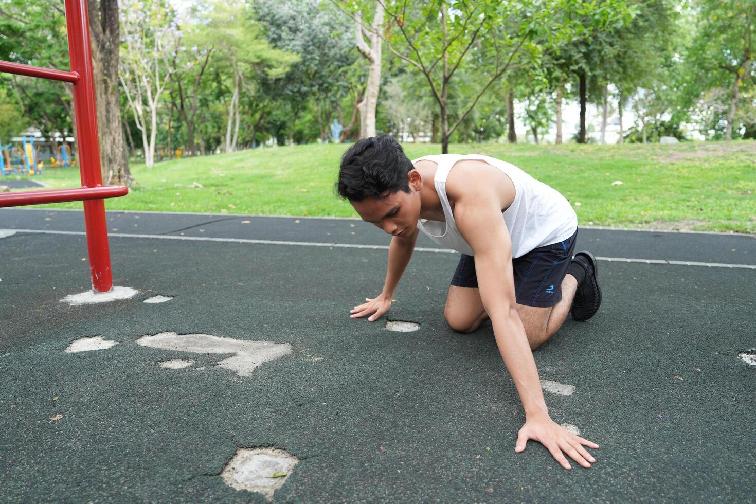 Asian man practicing gymnastics doing gymnastics bar and hoop exercises and stretching and resting for sports. photo