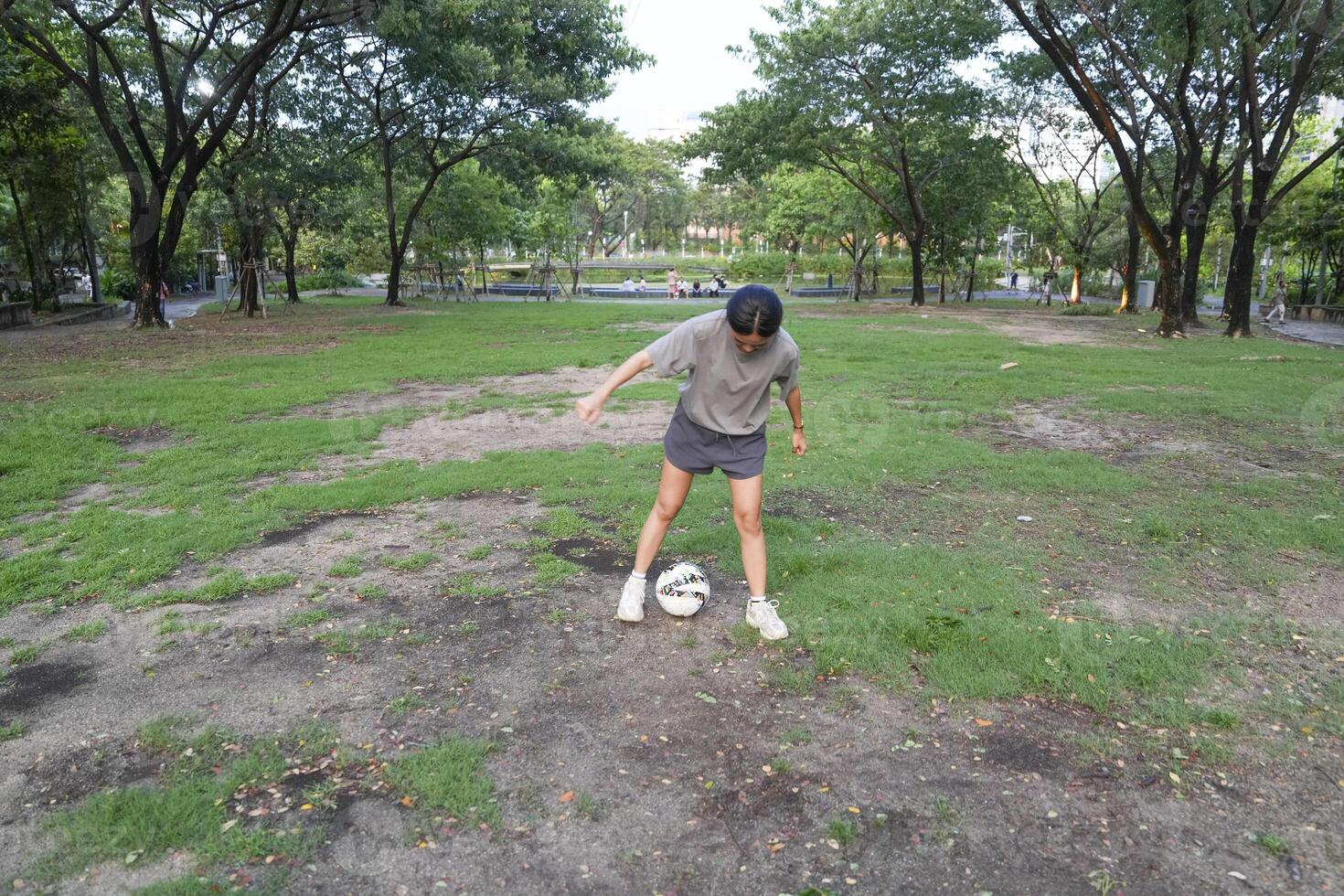 female soccer players practice using the ball in the park field diligently and happily. photo
