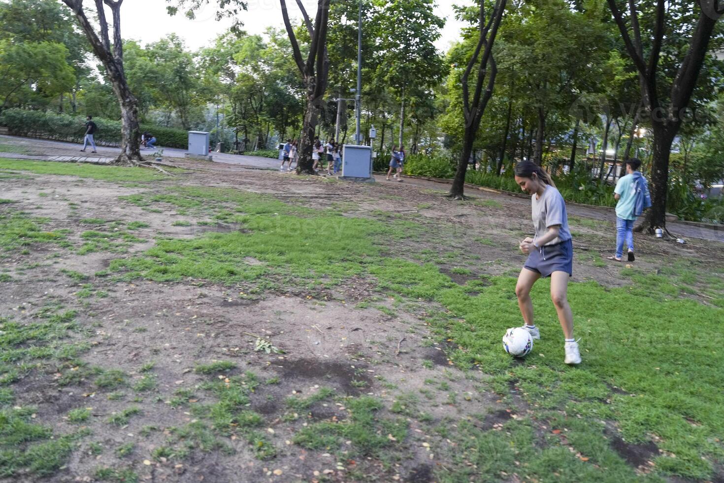 female soccer players practice using the ball in the park field diligently and happily. photo