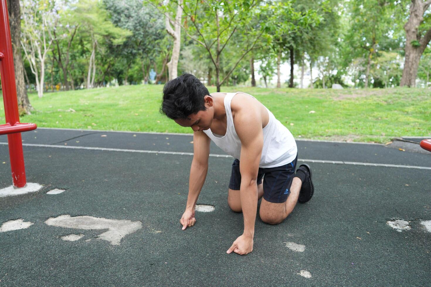 Asian man practicing gymnastics doing gymnastics bar and hoop exercises and stretching and resting for sports. photo