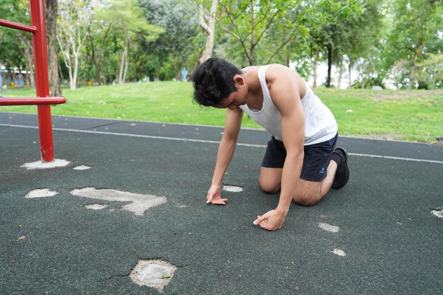 Asian man practicing gymnastics doing gymnastics bar and hoop exercises and stretching and resting for sports. photo